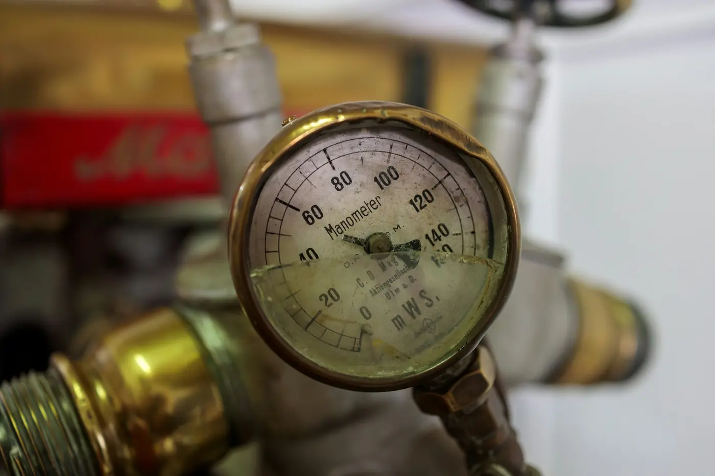 Brass water pressure gauge mounted on a pipe fitting