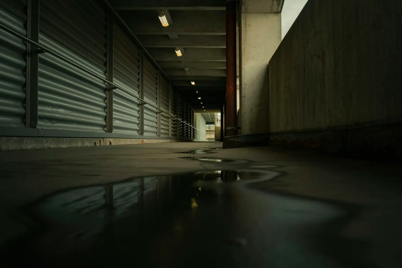 Dark hallway with water pooled across the floor