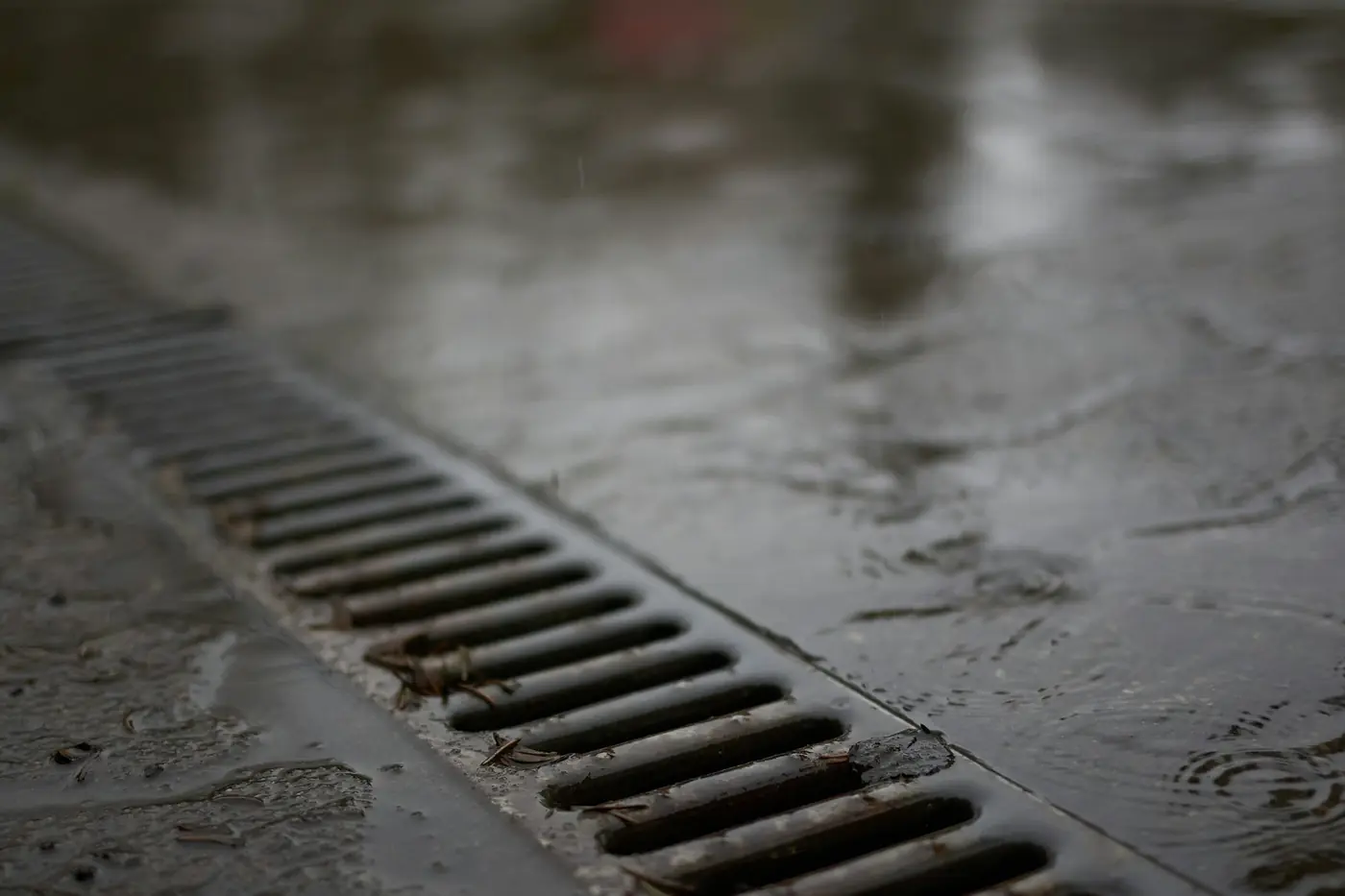 Metal floor drain grate on wet concrete