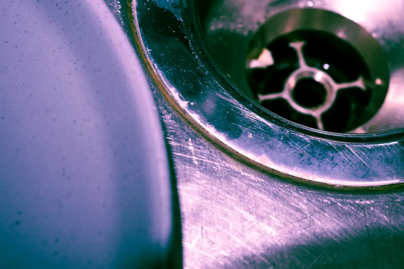 Close-up of a stainless steel sink drain opening