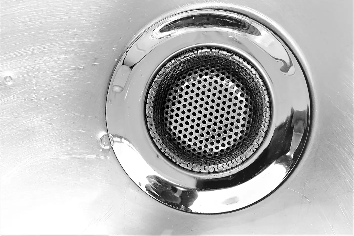 Close-up of a stainless steel sink drain strainer
