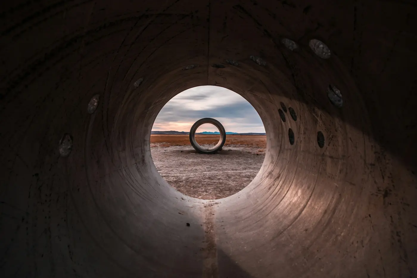 View through the inside of a large concrete pipe