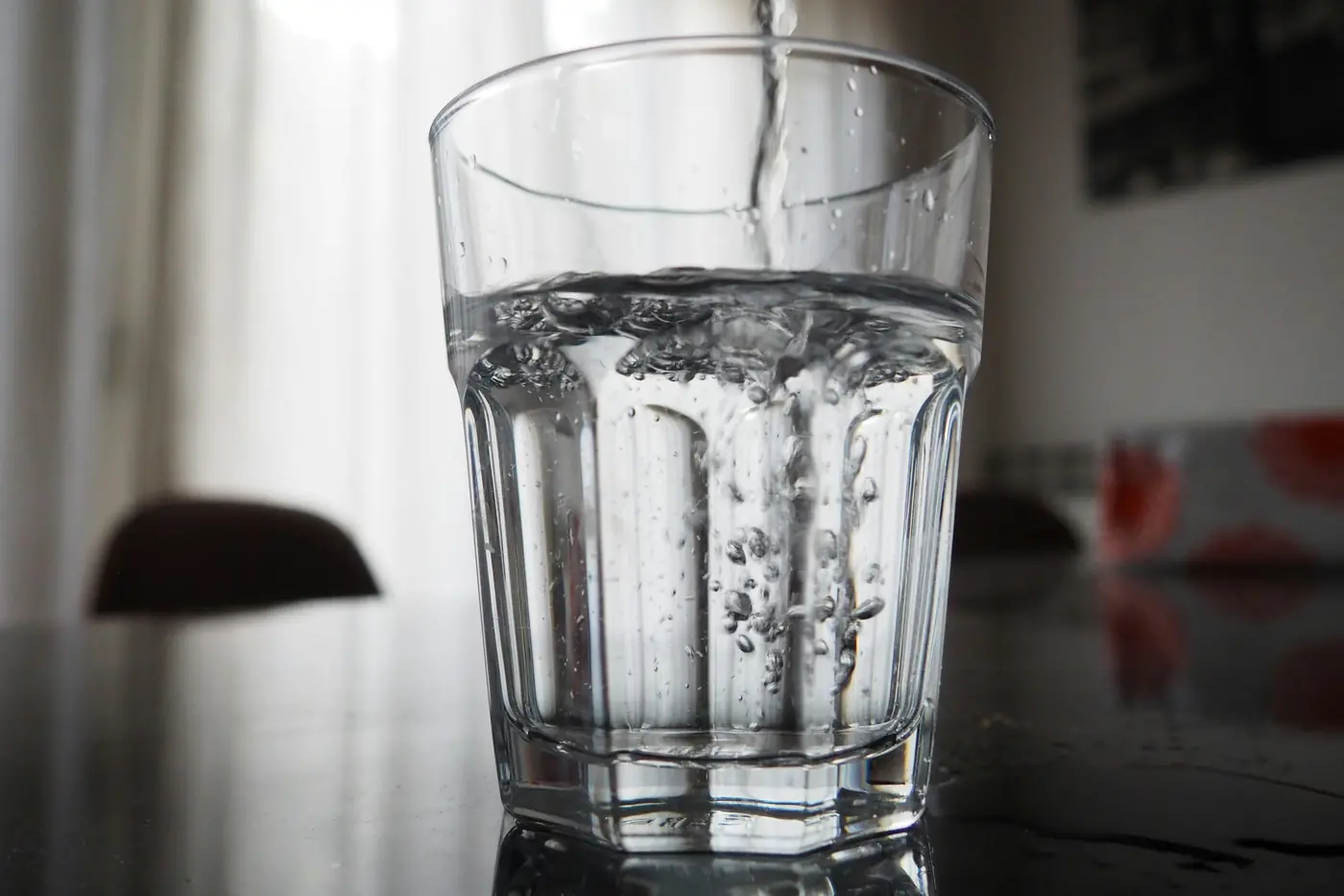 Clear drinking water being poured into a glass