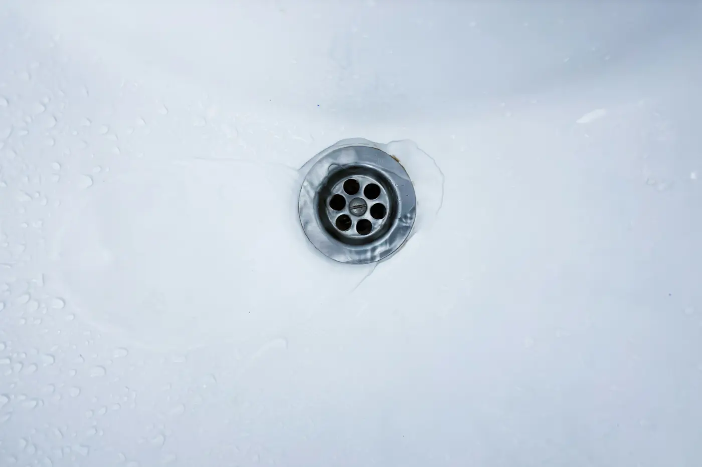 Chrome drain in a white basin