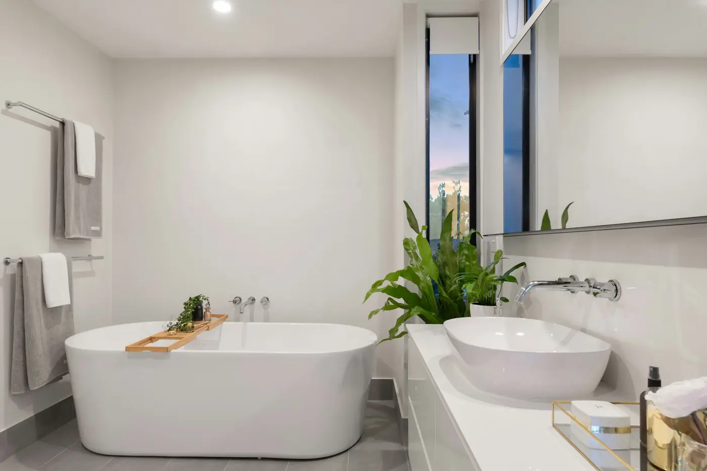 Bright bathroom with a freestanding white bathtub and vessel sink