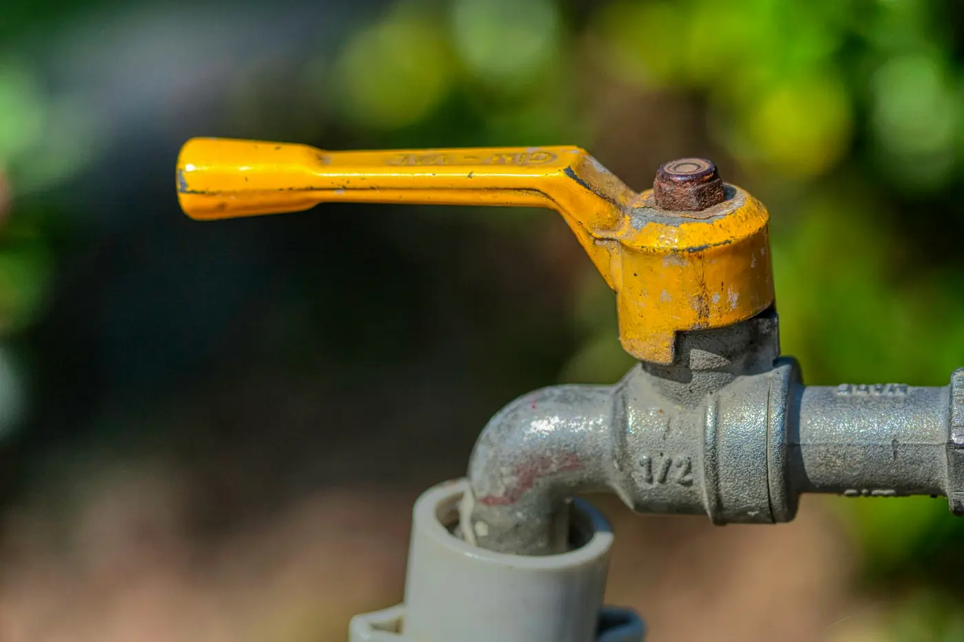 Yellow lever handle on a galvanized ball valve shutoff