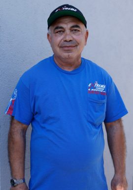 Extreme Plumbing crew member by a service van